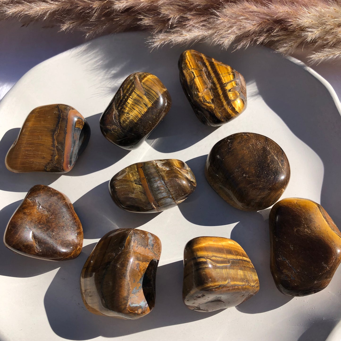 Large tigers eye tumbled stones