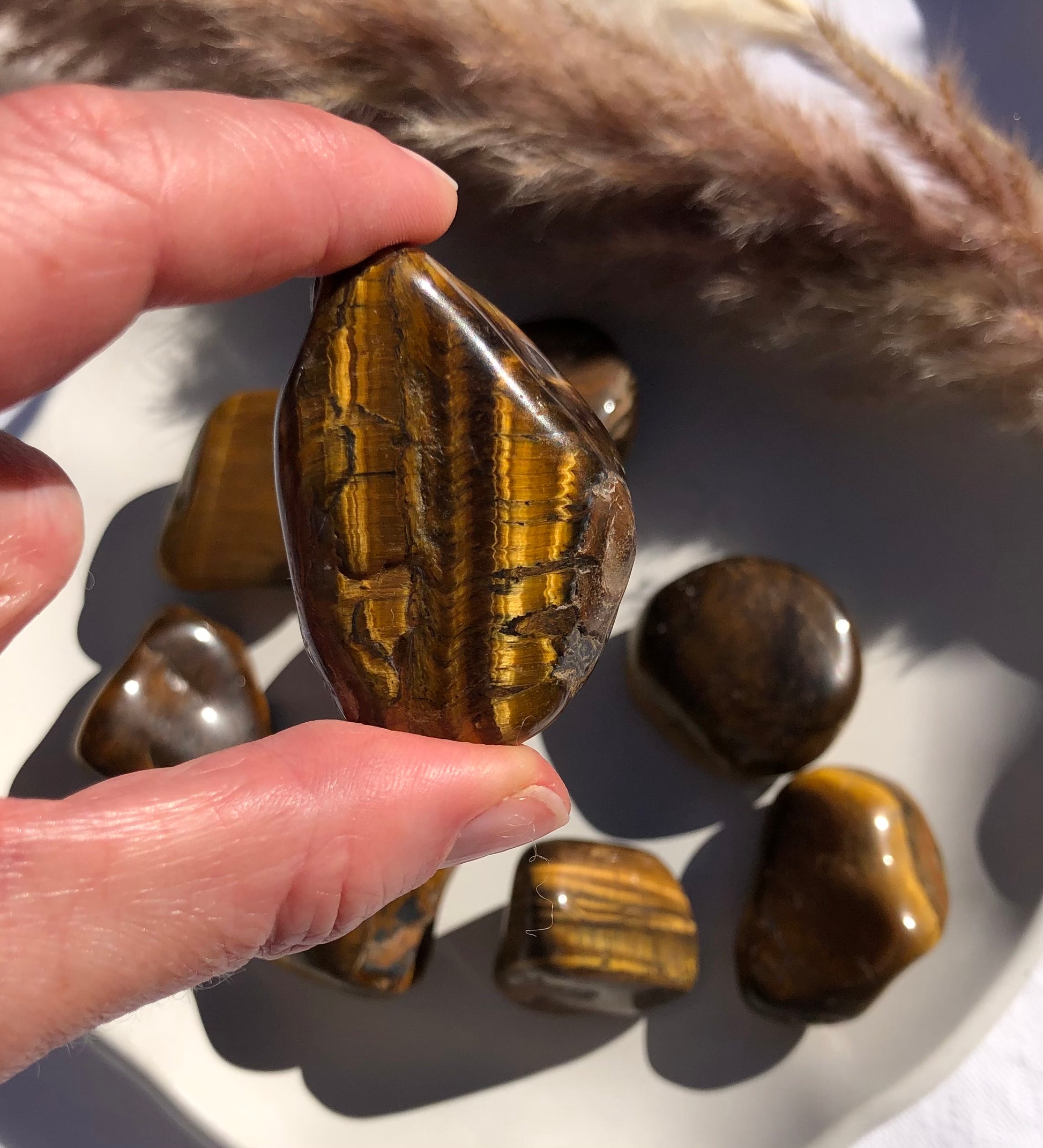 Large tigers eye tumbled stones